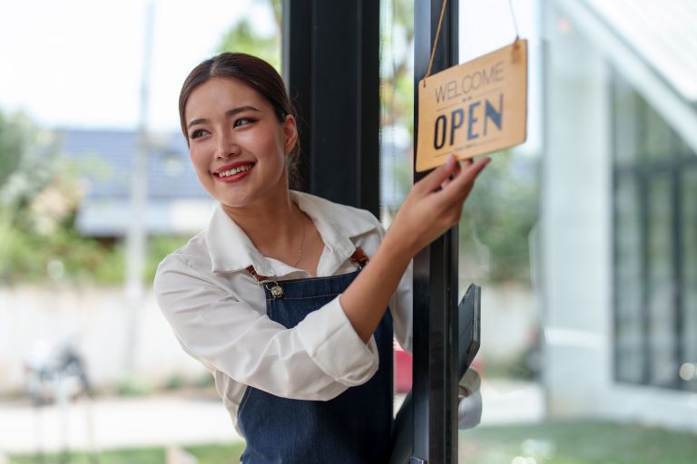 Business owner with open sign |Time tracking software for small businesses